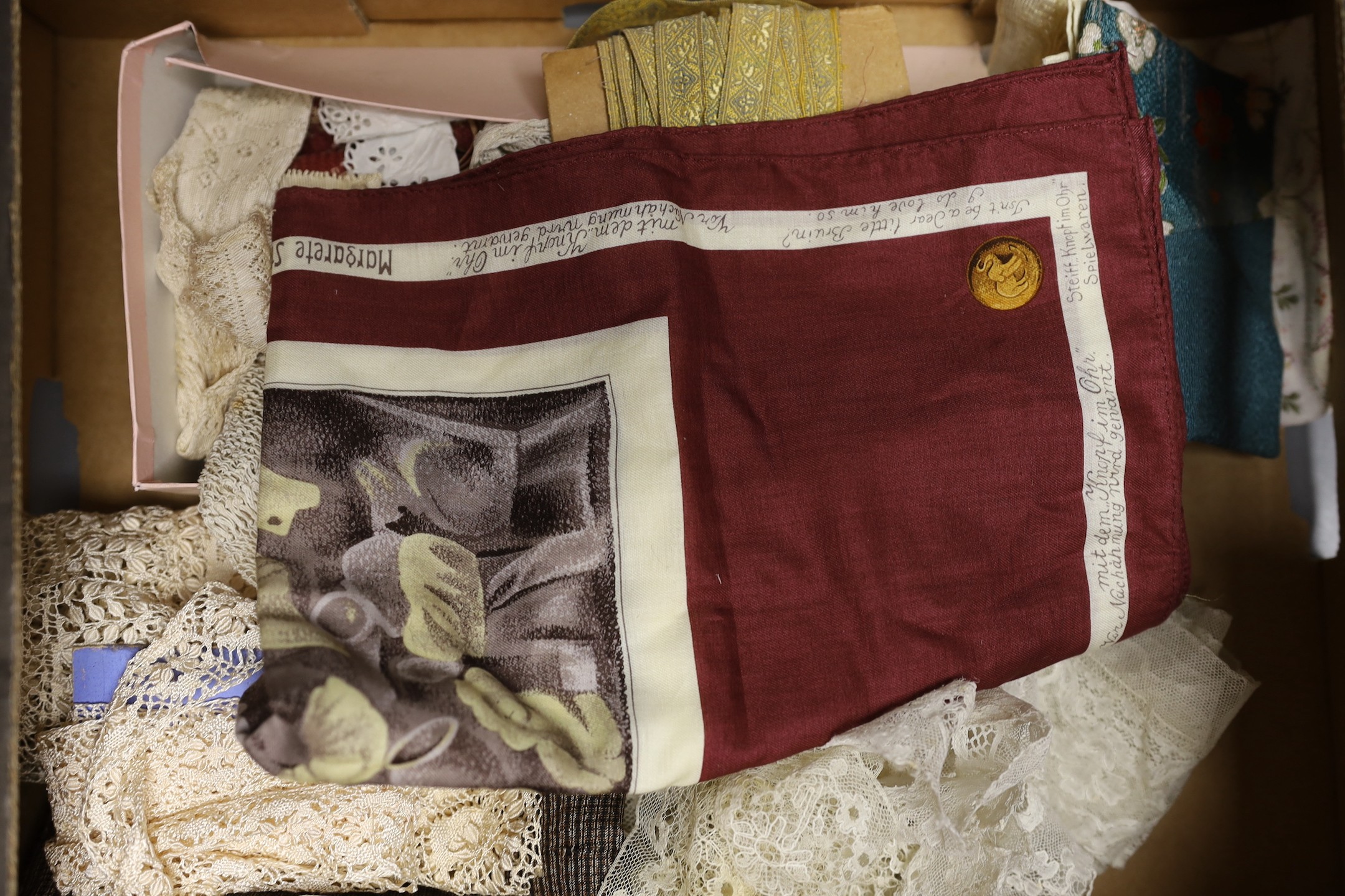 An unusual Steiff commemorative scarf, a collection of Victorian and later ribbons and a length of early 19th century fine bobbin lace, silk Maltese lace and silk mittens, etc.